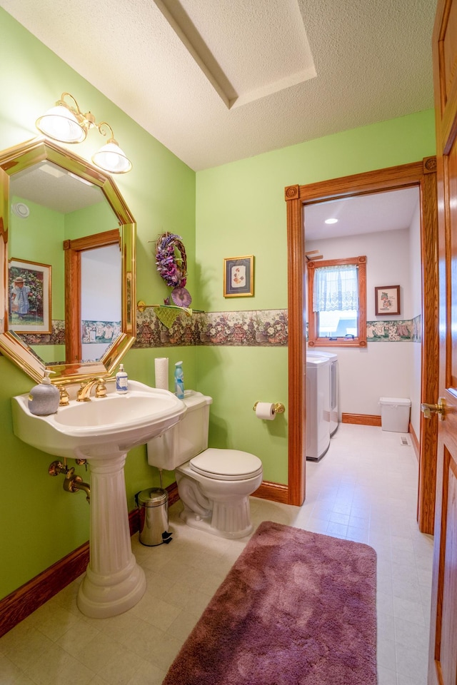 870 Andrew Dr NE, Lake Andrew Twp, MN 56273 - bathroom featuring independent washer and dryer and a textured ceiling