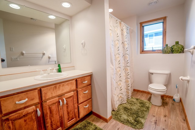 870 Andrew Dr NE, Lake Andrew Twp, MN 56273 - bathroom with vanity, wood finished floors, a shower with shower curtain, and recessed lighting