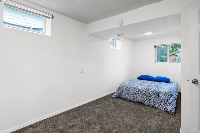 1620 7th St NW, New Brighton, MN 55112 - carpeted bedroom with baseboards and a textured ceiling