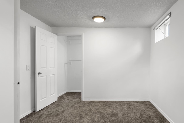 1620 7th St NW, New Brighton, MN 55112 - unfurnished bedroom with dark colored carpet, a textured ceiling, and a closet