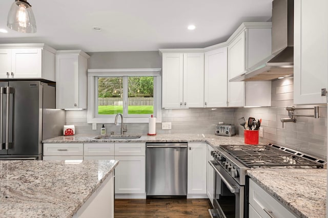 6712 Hillside Ln, Edina, MN 55439 - kitchen with appliances with stainless steel finishes, wall chimney range hood, white cabinets, backsplash, and recessed lighting