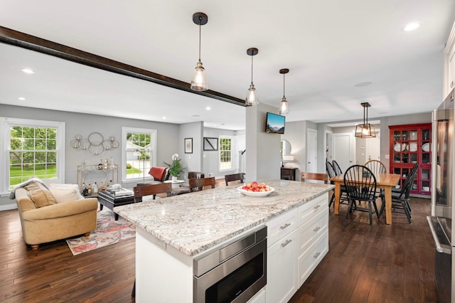 6712 Hillside Ln, Edina, MN 55439 - kitchen with stainless steel microwave, dark wood-style flooring, open floor plan, pendant lighting, and recessed lighting
