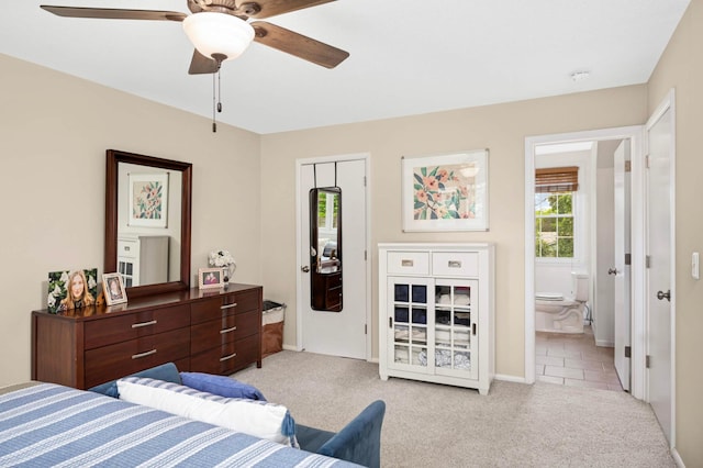 6712 Hillside Ln, Edina, MN 55439 - bedroom with multiple windows, light carpet, ensuite bath, and a ceiling fan
