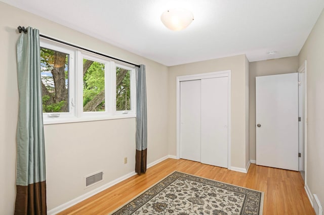 6712 Hillside Ln, Edina, MN 55439 - unfurnished bedroom with light wood finished floors and a closet