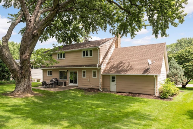 6712 Hillside Ln, Edina, MN 55439 - back of property with a yard, a chimney, a patio area, and roof with shingles