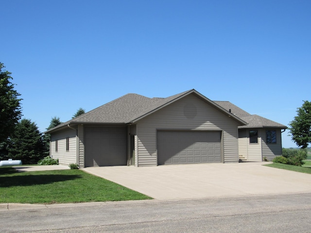 316 8th St NE, Fulda, MN 56131 - view of front of property featuring a garage, concrete driveway, a front lawn, and roof with shingles