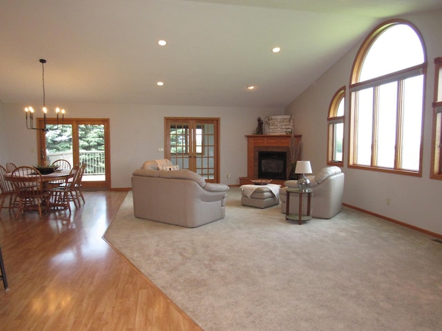 316 8th St NE, Fulda, MN 56131 - living area featuring a chandelier, a fireplace with raised hearth, wood finished floors, and recessed lighting