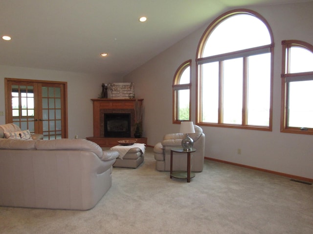 316 8th St NE, Fulda, MN 56131 - carpeted living room with plenty of natural light, recessed lighting, vaulted ceiling, a fireplace with raised hearth, and french doors