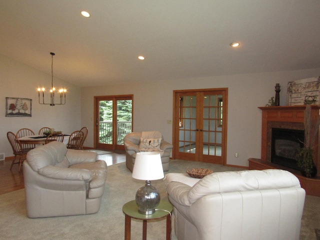 316 8th St NE, Fulda, MN 56131 - living room featuring a chandelier, vaulted ceiling, recessed lighting, a glass covered fireplace, and french doors
