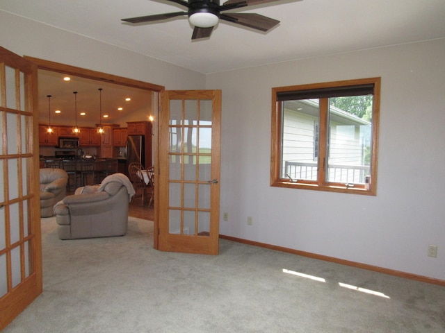 316 8th St NE, Fulda, MN 56131 - living room with french doors, light carpet, and a ceiling fan