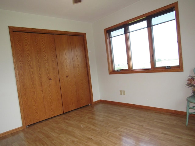 316 8th St NE, Fulda, MN 56131 - unfurnished bedroom featuring light wood-style flooring and a closet