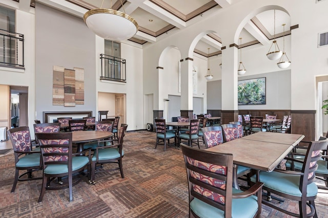 1666 Coffman St Unit 101, Falcon Heights, MN 55108 - dining room with a towering ceiling, coffered ceiling, beam ceiling, dark carpet, and arched walkways