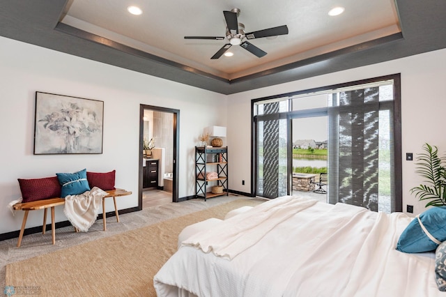 7373 14th St S, Fargo, ND 58104 - carpeted bedroom featuring a tray ceiling, access to exterior, recessed lighting, a water view, and connected bathroom