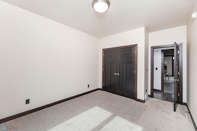 7373 14th St S, Fargo, ND 58104 - unfurnished bedroom with carpet flooring, a textured ceiling, and a closet