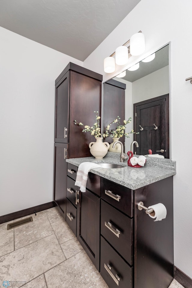 7373 14th St S, Fargo, ND 58104 - bathroom featuring tile patterned flooring and vanity