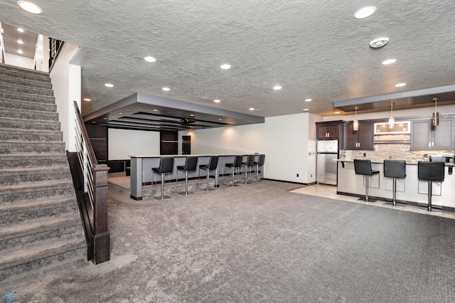 7373 14th St S, Fargo, ND 58104 - living room with light colored carpet, stairway, a community bar, and recessed lighting
