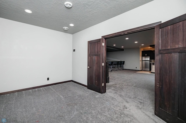 7373 14th St S, Fargo, ND 58104 - carpeted spare room featuring recessed lighting, a textured ceiling, and a smoke detector