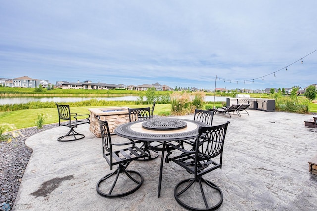 7373 14th St S, Fargo, ND 58104 - view of patio / terrace with an outdoor fire pit, a water view, and a residential view