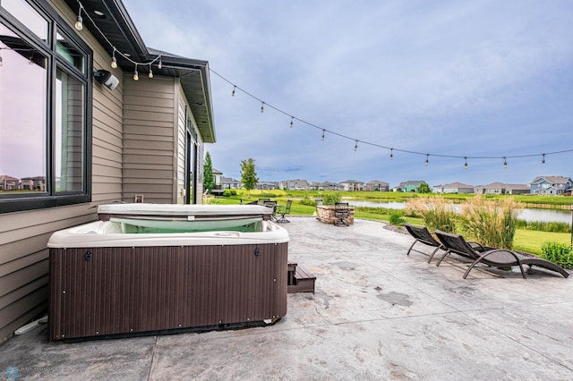7373 14th St S, Fargo, ND 58104 - view of patio / terrace featuring a hot tub, a residential view, and a water view