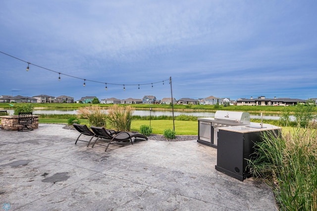 7373 14th St S, Fargo, ND 58104 - view of patio / terrace with a residential view, a water view, and grilling area
