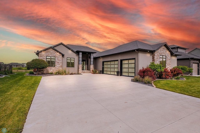 7373 14th St S, Fargo, ND 58104 - view of front of house with stone siding, concrete driveway, a garage, and a front yard