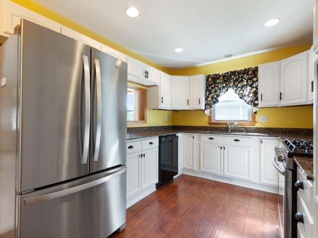 3568 Feldman Ave SE, Buffalo, MN 55313 - kitchen featuring appliances with stainless steel finishes, dark countertops, white cabinetry, plenty of natural light, and recessed lighting