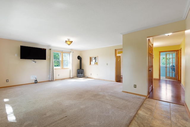 3568 Feldman Ave SE, Buffalo, MN 55313 - unfurnished living room with a wood stove, crown molding, and light colored carpet