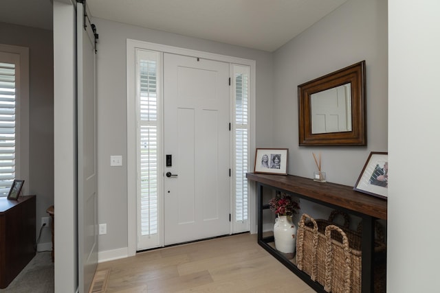 14714 146th Ave N, Dayton, MN 55327 - entryway featuring light wood-type flooring, healthy amount of natural light, and a barn door