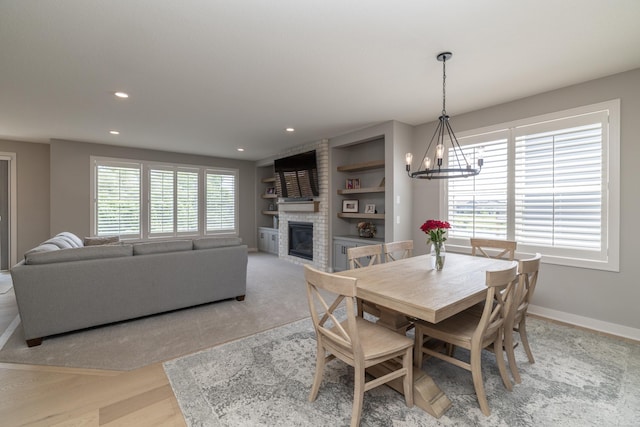 14714 146th Ave N, Dayton, MN 55327 - dining room featuring a chandelier, a brick fireplace, recessed lighting, and built in shelves