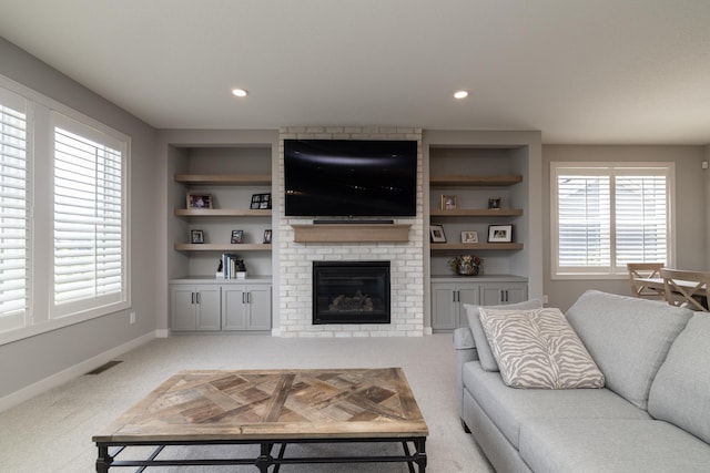 14714 146th Ave N, Dayton, MN 55327 - living area with light carpet, a brick fireplace, and built in shelves