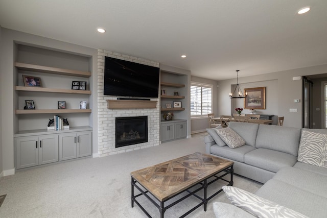 14714 146th Ave N, Dayton, MN 55327 - carpeted living room with a chandelier, a brick fireplace, built in shelves, and recessed lighting