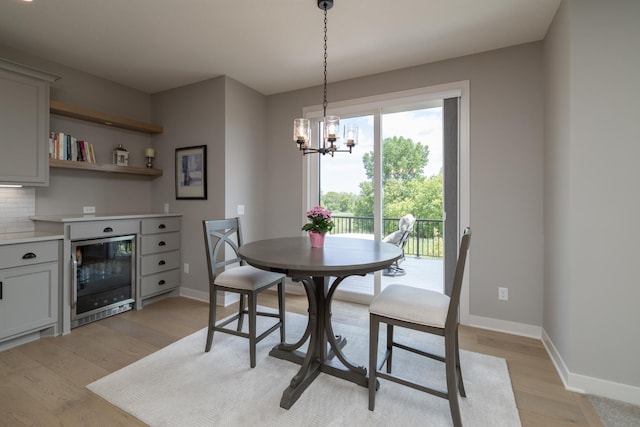 14714 146th Ave N, Dayton, MN 55327 - dining space featuring wine cooler, a chandelier, and light wood finished floors