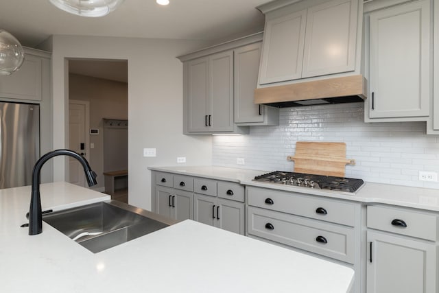 14714 146th Ave N, Dayton, MN 55327 - kitchen featuring stainless steel appliances, tasteful backsplash, light countertops, exhaust hood, and gray cabinetry