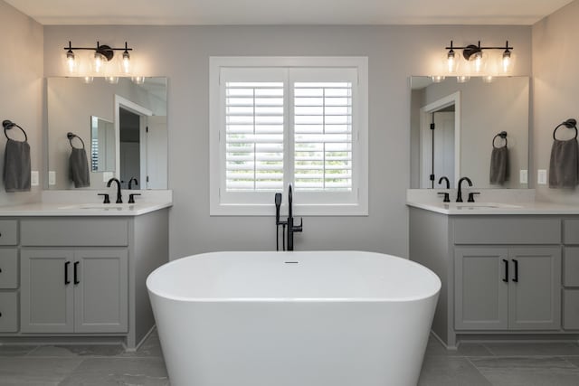 14714 146th Ave N, Dayton, MN 55327 - bathroom featuring two vanities, a freestanding tub, and marble look tile flooring