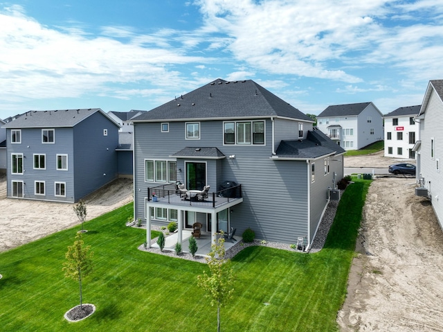 14714 146th Ave N, Dayton, MN 55327 - back of house featuring a patio area, a residential view, a yard, a shingled roof, and a wooden deck