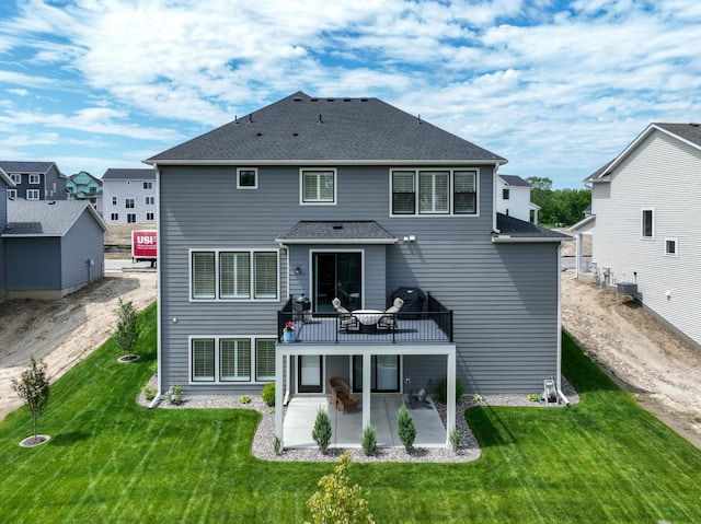 14714 146th Ave N, Dayton, MN 55327 - back of property featuring a patio area, a lawn, a deck, and roof with shingles