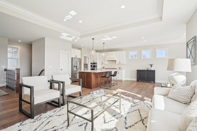 14147 77th Ln NE, Otsego, MN 55330 - living room with a tray ceiling, ornamental molding, recessed lighting, light wood-type flooring, and plenty of natural light