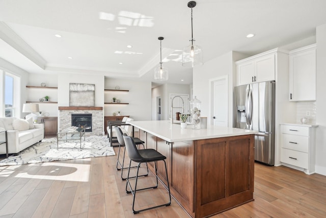 14147 77th Ln NE, Otsego, MN 55330 - kitchen with stainless steel fridge with ice dispenser, a raised ceiling, light wood-style floors, light countertops, and recessed lighting