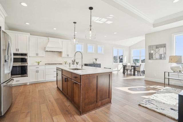 14147 77th Ln NE, Otsego, MN 55330 - kitchen with custom exhaust hood, appliances with stainless steel finishes, recessed lighting, light countertops, and white cabinets