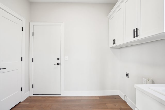14147 77th Ln NE, Otsego, MN 55330 - washroom featuring cabinet space, hookup for an electric dryer, and light wood-style flooring