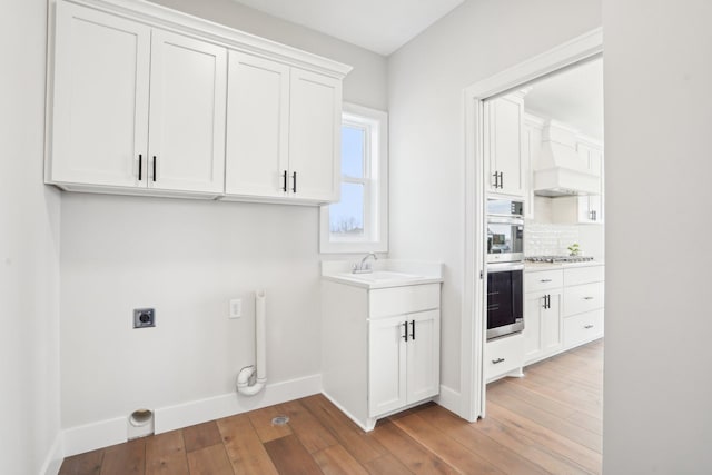 14147 77th Ln NE, Otsego, MN 55330 - laundry area featuring electric dryer hookup and light wood-style flooring