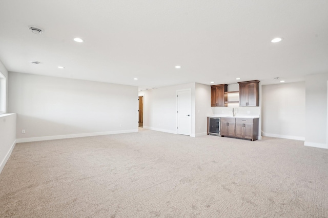 14147 77th Ln NE, Otsego, MN 55330 - unfurnished living room with bar with sink, recessed lighting, light carpet, and beverage cooler