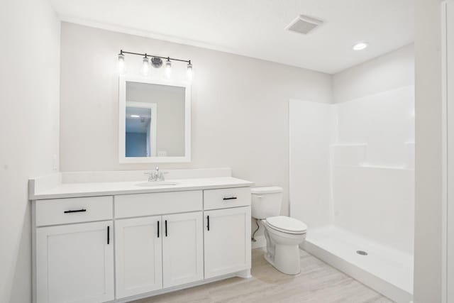14147 77th Ln NE, Otsego, MN 55330 - bathroom featuring vanity, wood finished floors, and a shower