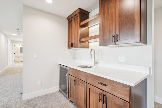 14147 77th Ln NE, Otsego, MN 55330 - kitchen with beverage cooler, light carpet, light countertops, recessed lighting, and brown cabinetry