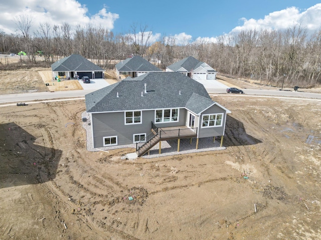 14147 77th Ln NE, Otsego, MN 55330 - back of house featuring stairs, roof with shingles, and a deck