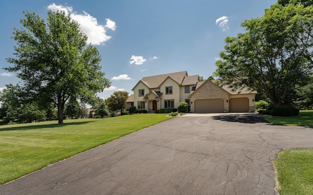160 River Bluff Pl NW, Cascade Twp, MN 55901 - traditional home featuring a garage, stucco siding, asphalt driveway, a front yard, and stone siding