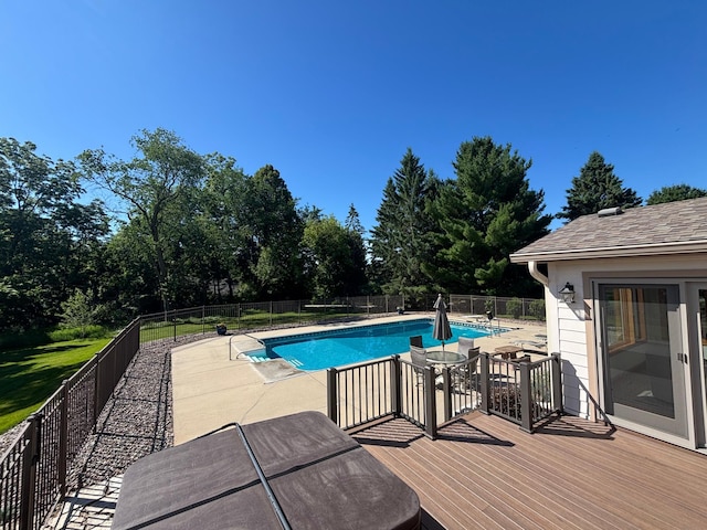 160 River Bluff Pl NW, Cascade Twp, MN 55901 - view of pool with a fenced backyard, a patio, a wooden deck, and view of wooded area