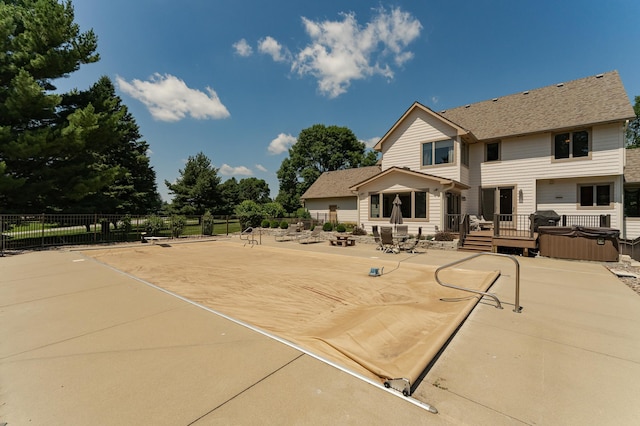 160 River Bluff Pl NW, Cascade Twp, MN 55901 - back of house with a hot tub, a patio area, roof with shingles, and a wooden deck