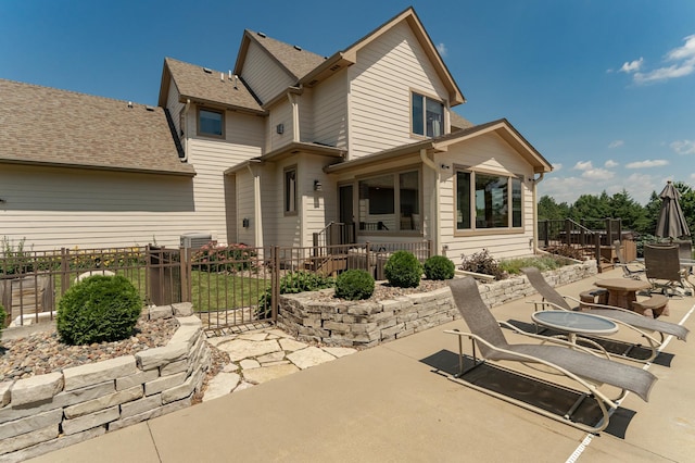 160 River Bluff Pl NW, Cascade Twp, MN 55901 - back of property featuring a patio area and roof with shingles