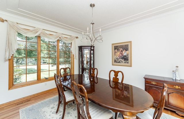 160 River Bluff Pl NW, Cascade Twp, MN 55901 - dining room with ornamental molding, wood finished floors, and a chandelier
